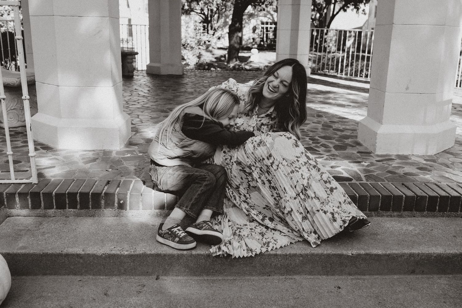 A series of black and white photographs showing homeless people sleeping on city streets and sidewalks.