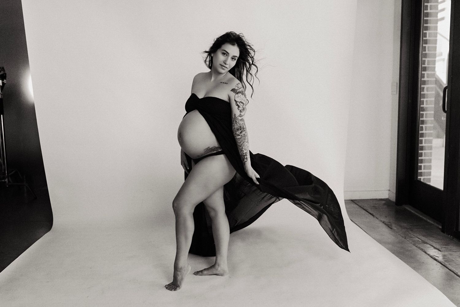 Black and white photo series showing artistic dance poses against a white studio backdrop.