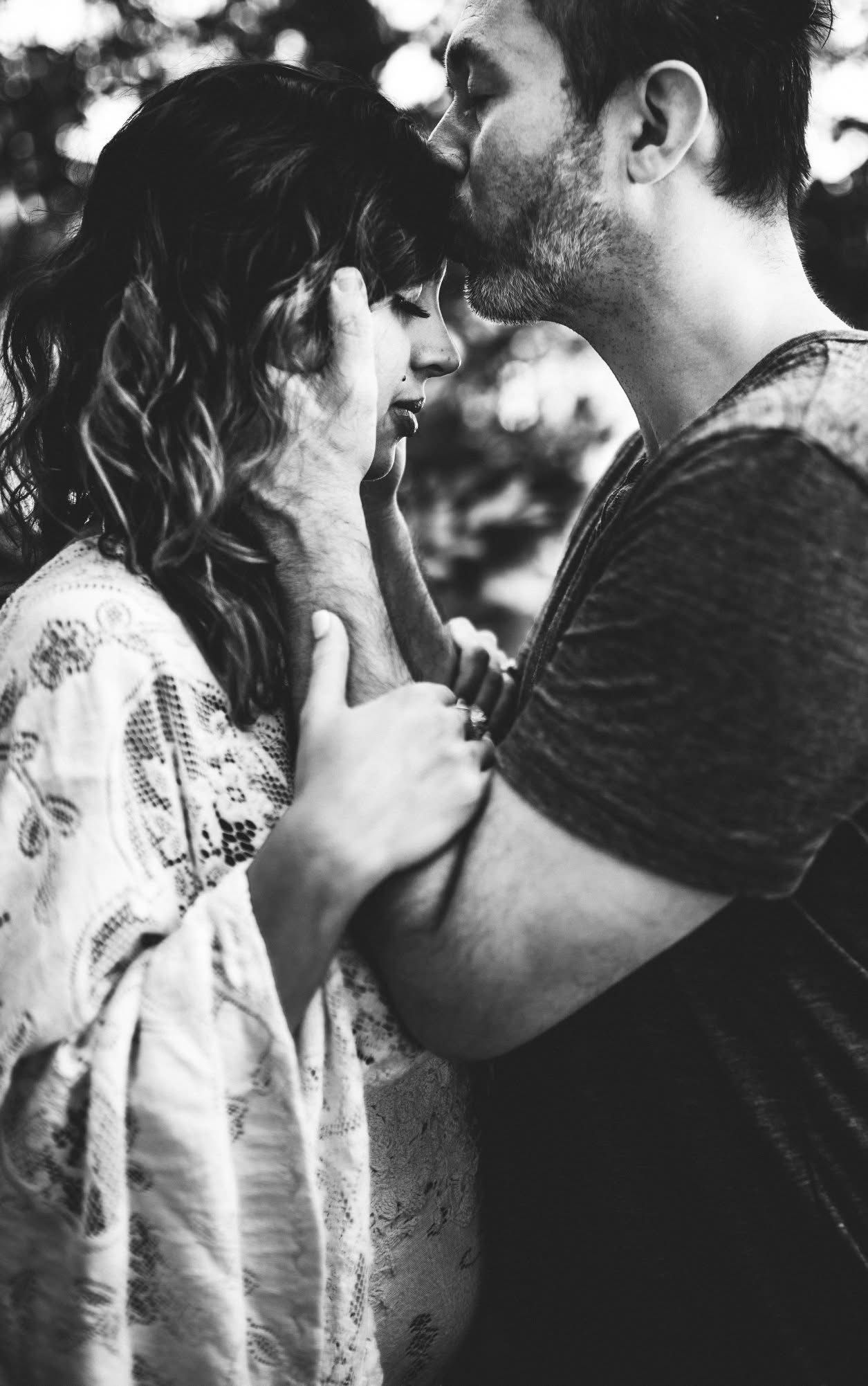 Intimate black and white portrait showing tender romantic moment.