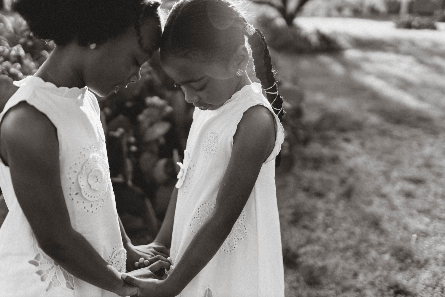 Black and white outdoor portraits showing intimate moments in white dresses.