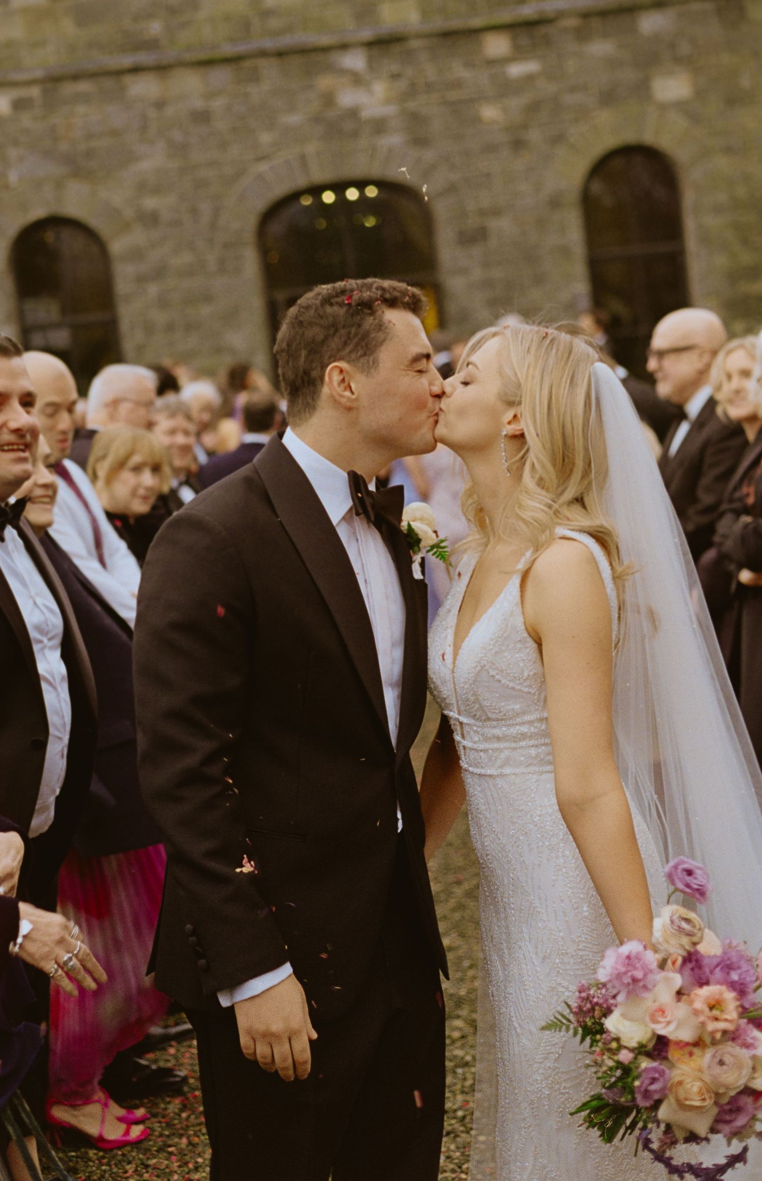 A romantic wedding kiss sequence showing multiple angles of the couple sharing their first kiss as newlyweds.