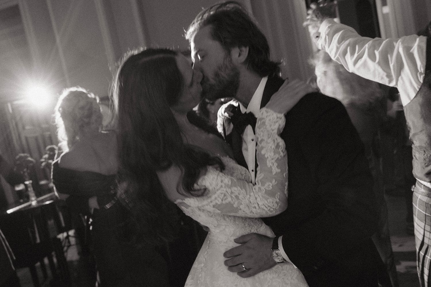 Black and white dance floor photos showing couples dancing at a wedding reception in dim lighting.