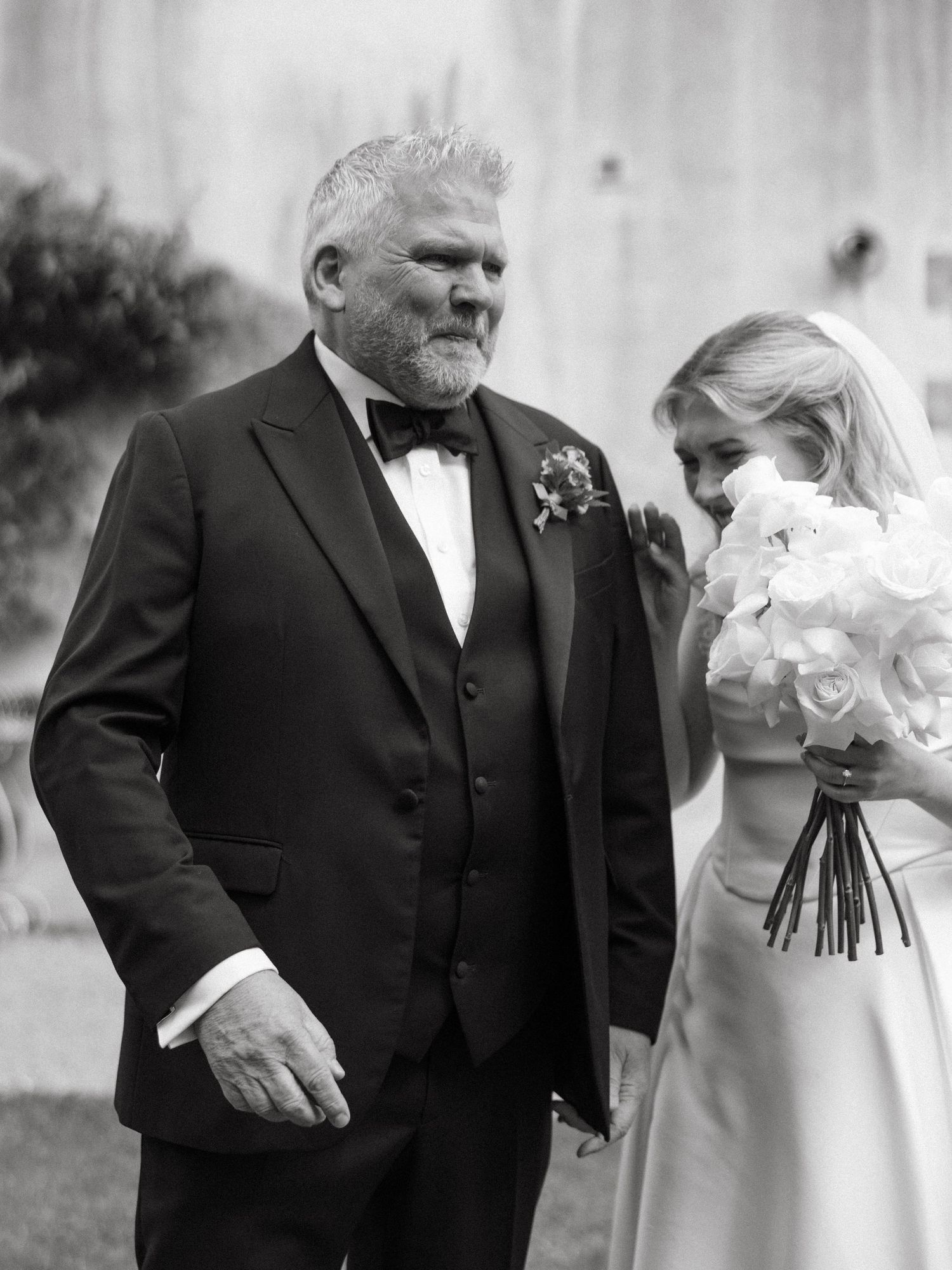 Black and white portrait of wedding party members in formal attire.