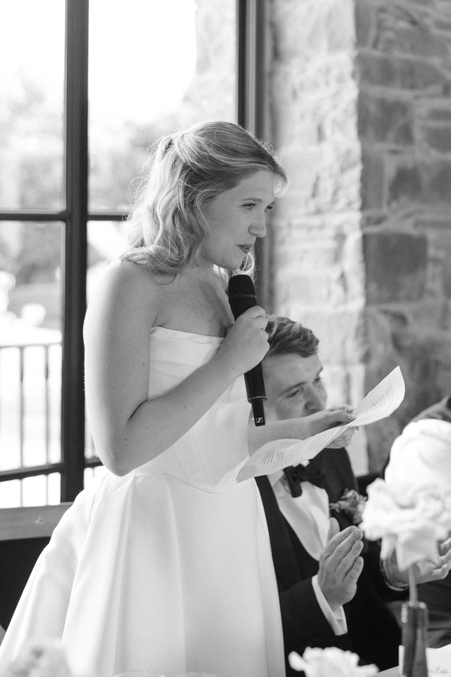 Series of emotional black and white photos capturing reactions during wedding speeches.