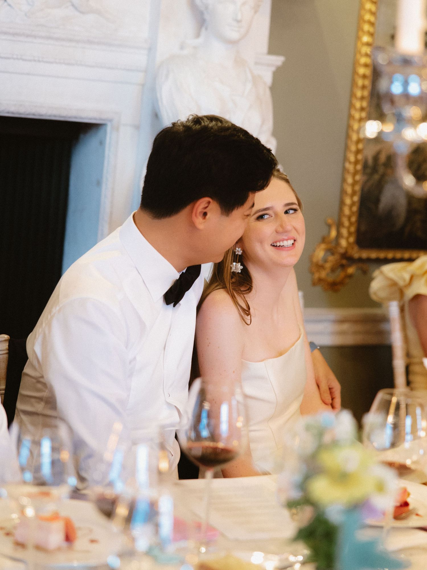 Intimate moment shared during an elegant wedding reception dinner.