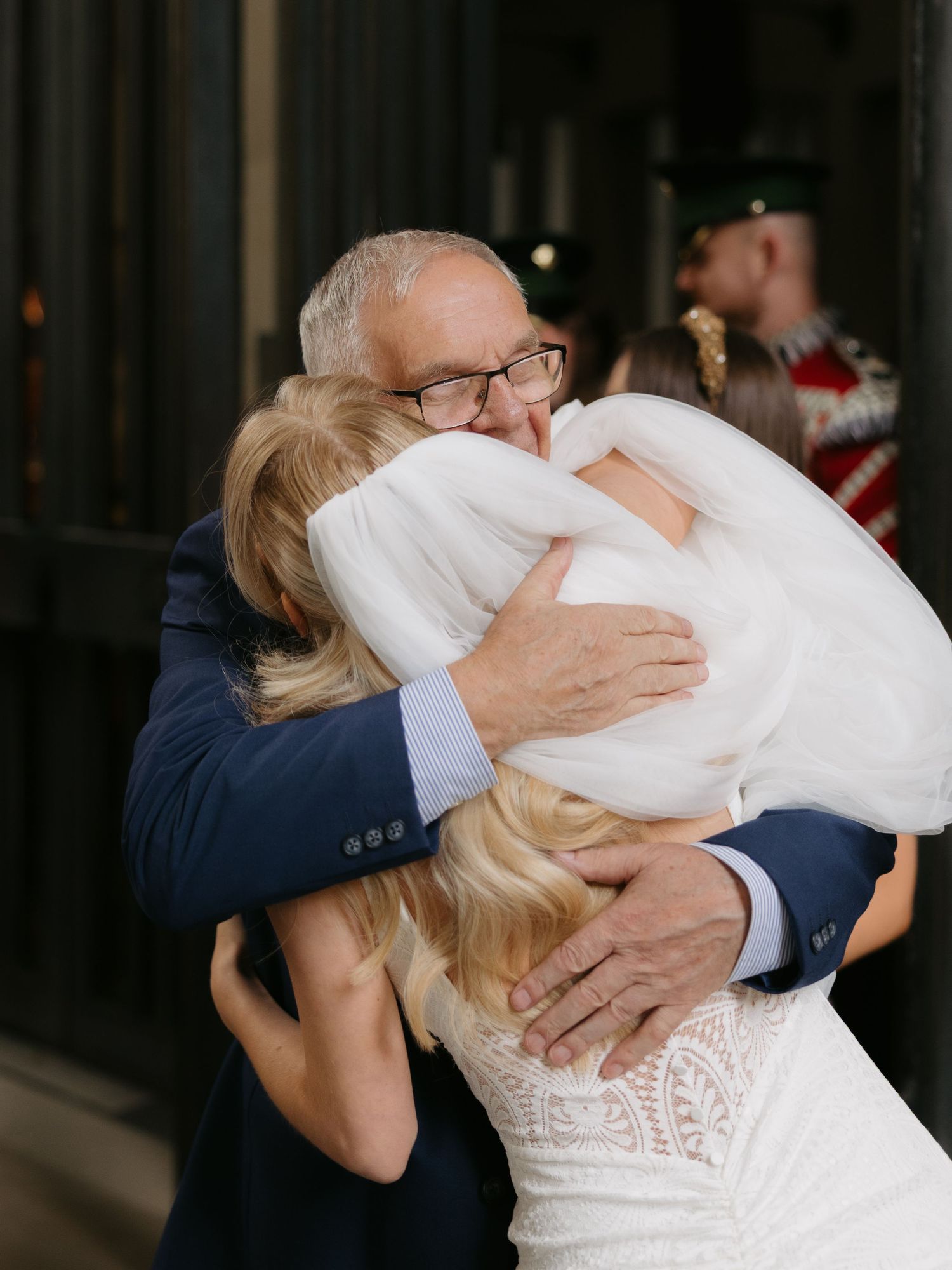 Four sequential photos capture a tender embrace between a bride in white lace and someone in a dark suit.