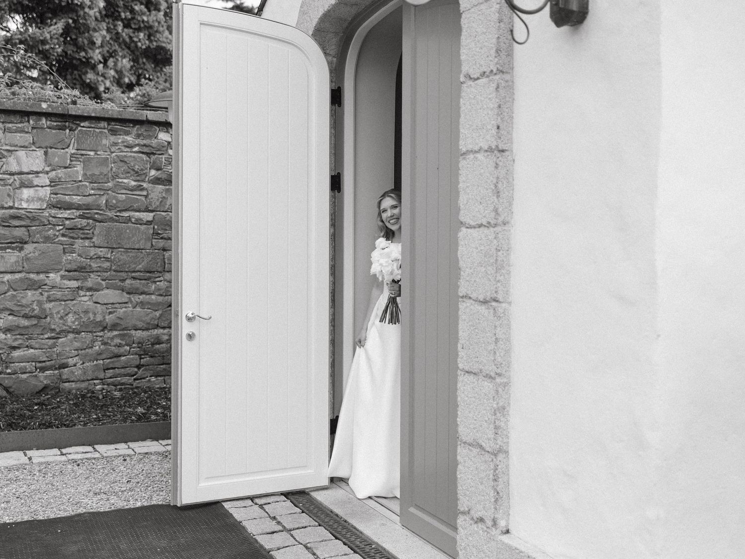 Elegant white stone building entrance with architectural details at a wedding venue.