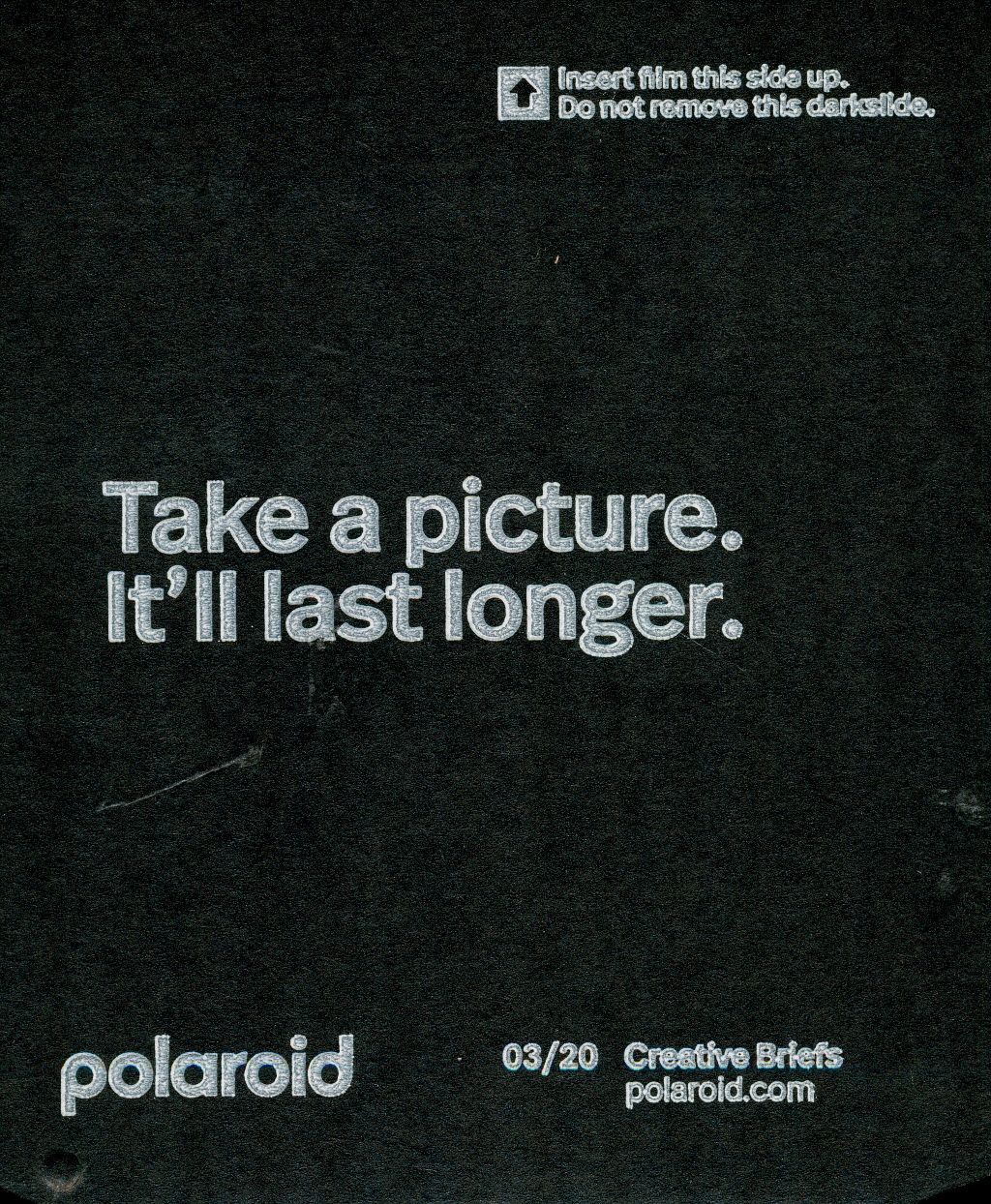 Black Polaroid advertisement with white text saying 