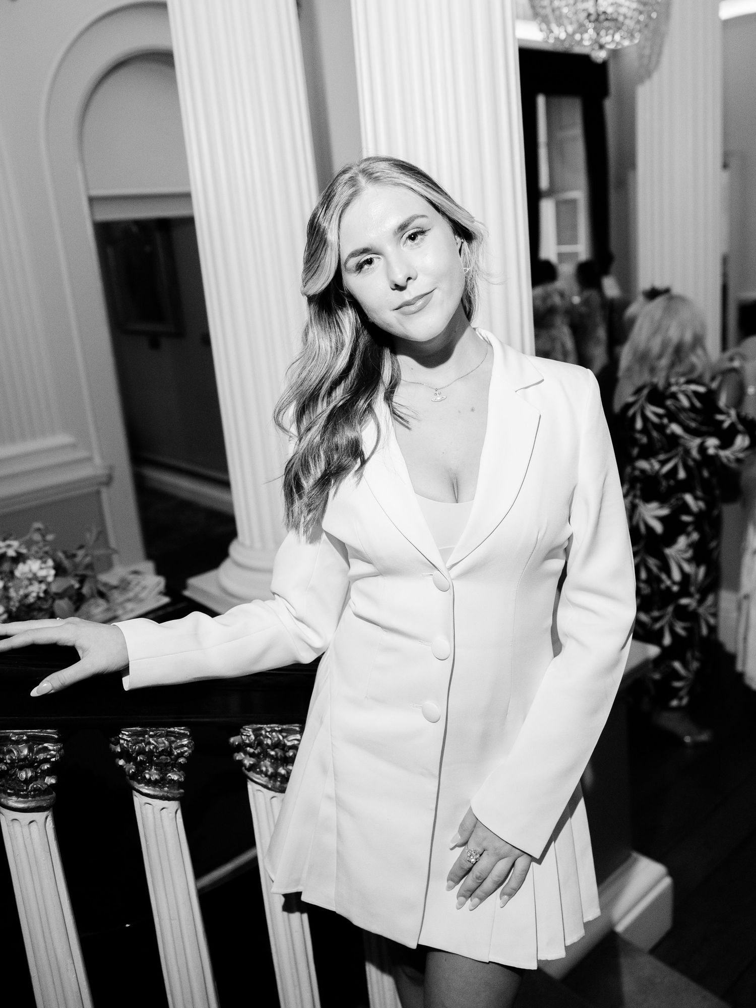 A black and white portrait series showing a person in a white top posing against an ornate interior background.