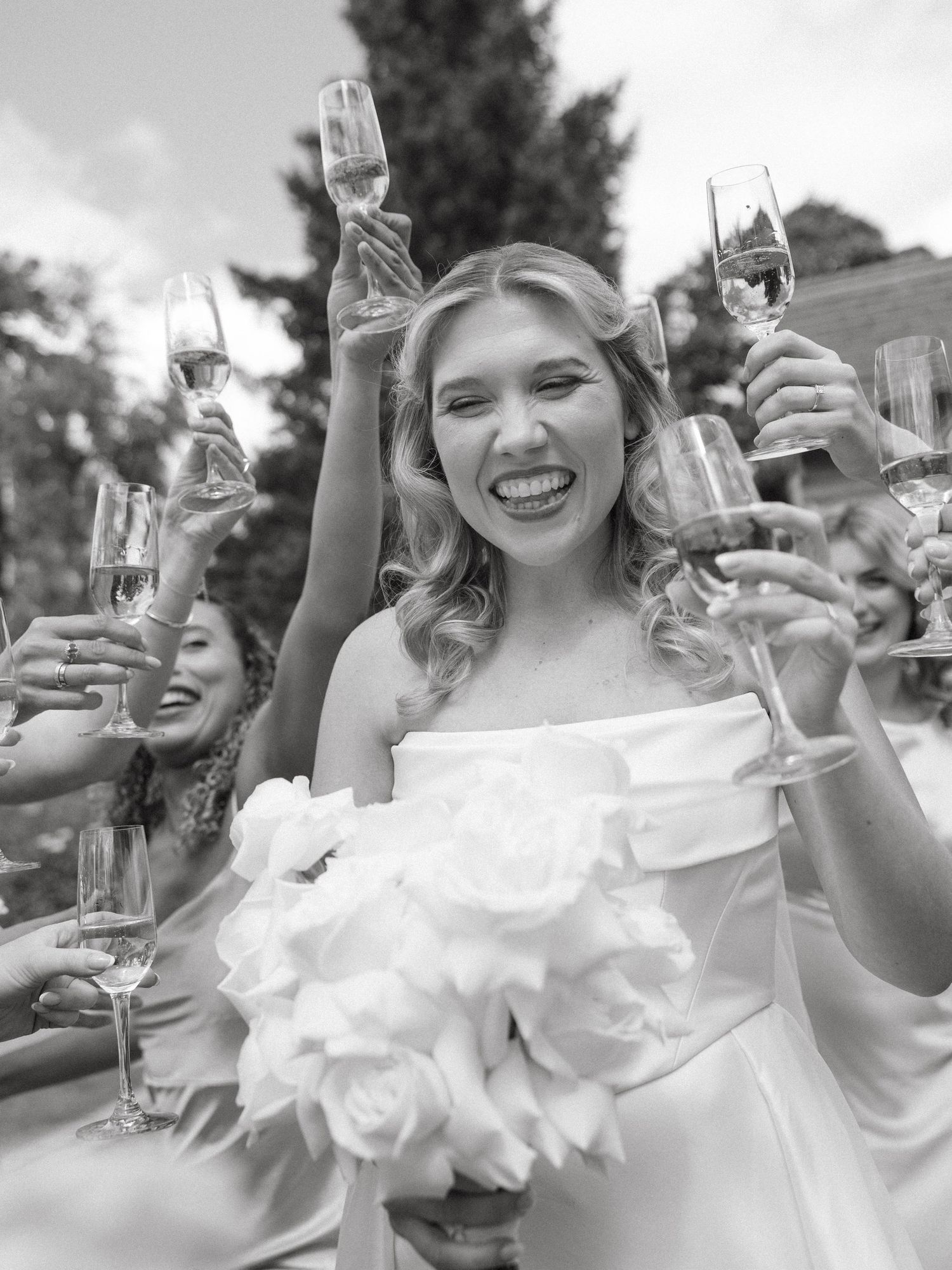 Celebratory champagne toast moments captured in black and white photography.