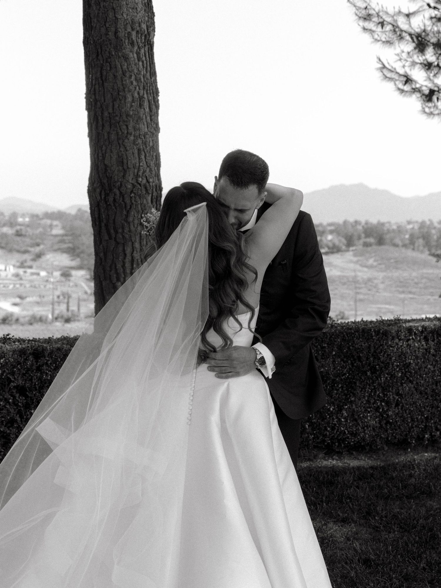 A romantic black and white wedding photography sequence showing a couple sharing tender moments outdoors.