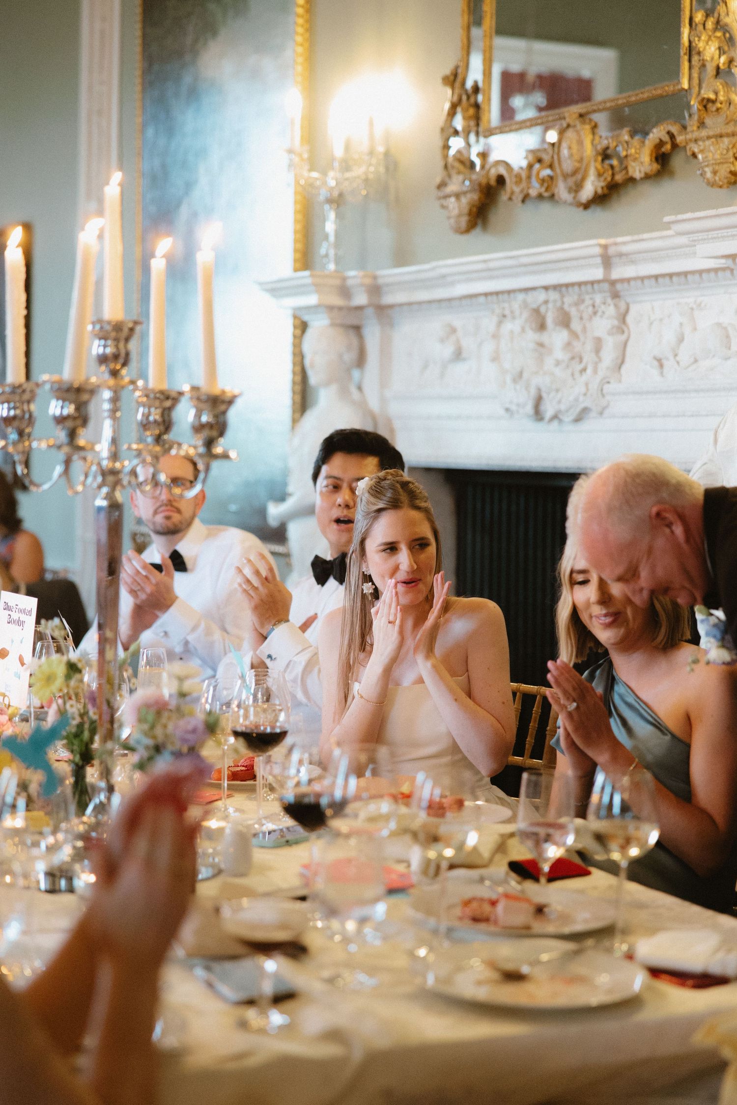 Elegant wedding reception with candelabras and ornate decor in formal dining room.