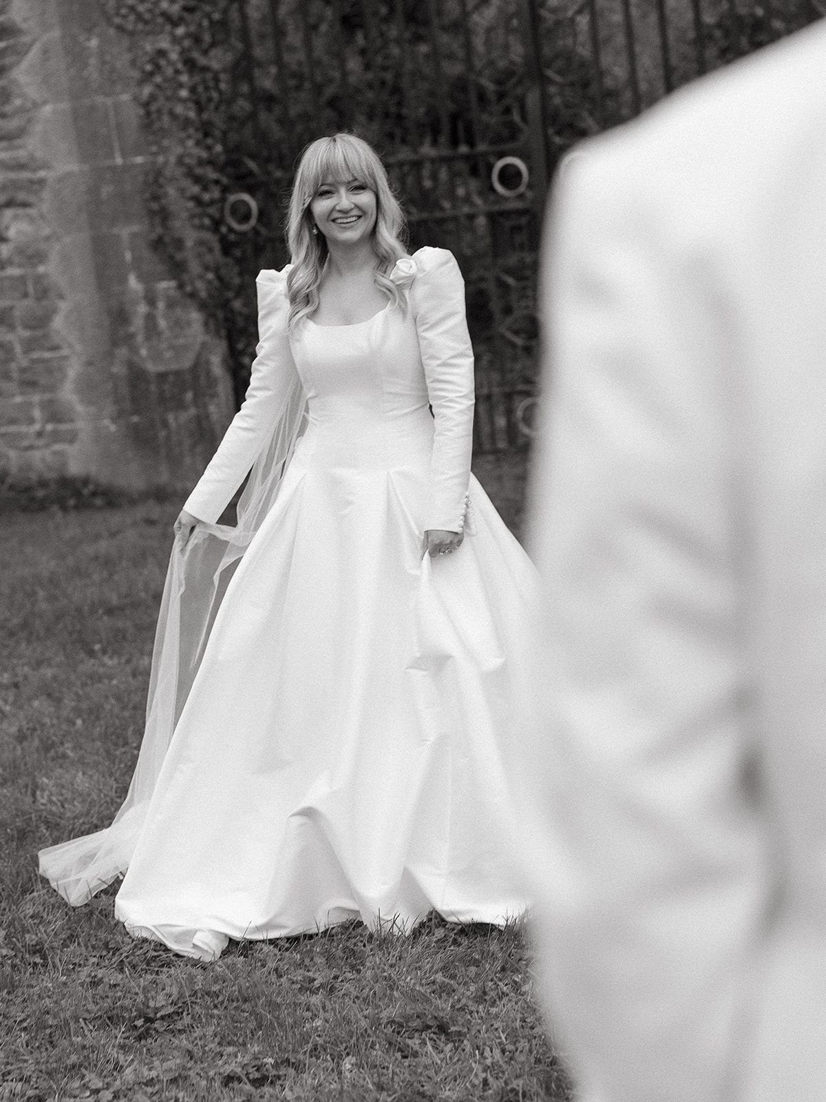 Flowing white dress movement captured in black and white photography outdoors.