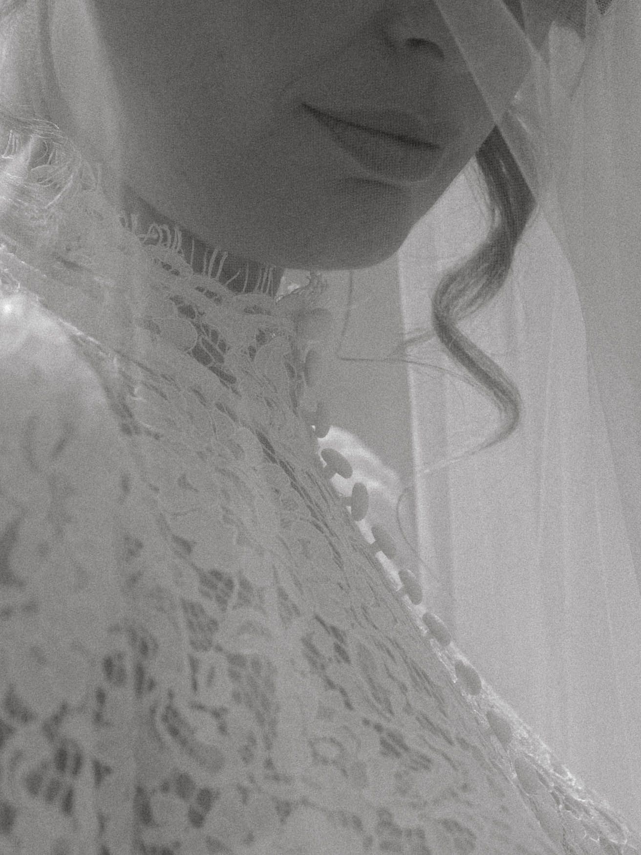 Close-up black and white portrait with delicate lace details.