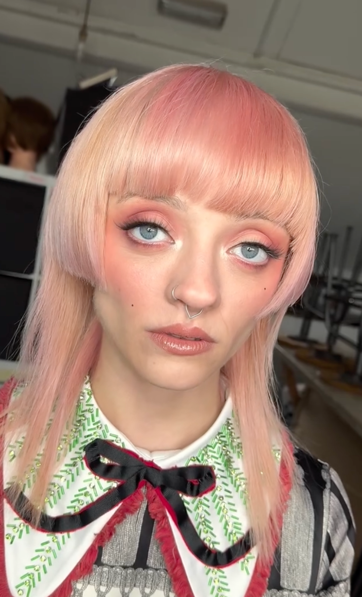 A series of selfie poses showing pink hair, green leaf-patterned collar, and red bow tie details.