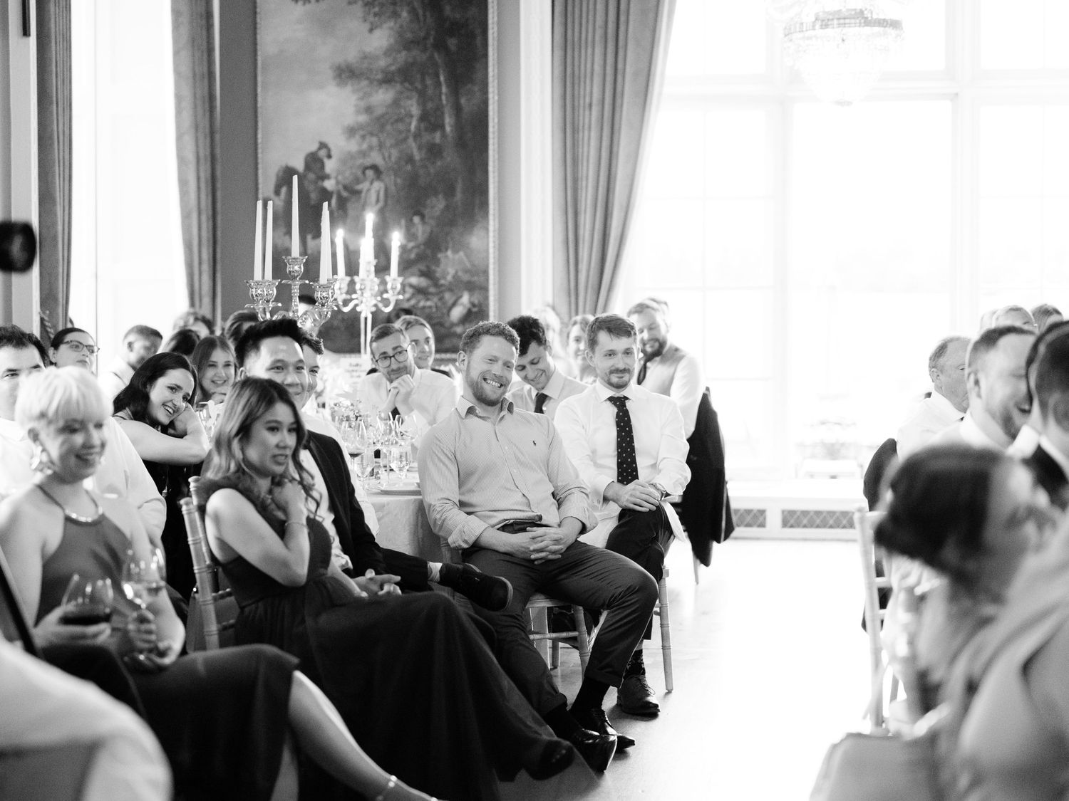 A black and white photo montage shows multiple candid moments of guests at a formal event or wedding reception.