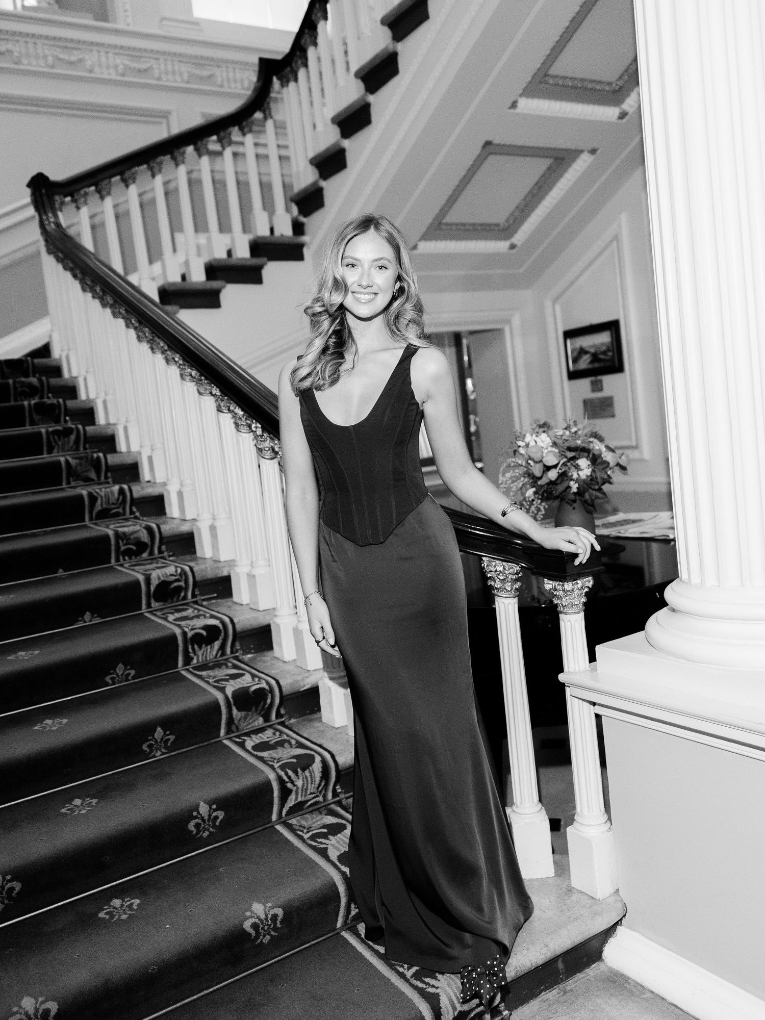 Sequence of elegant formal event photos showing a stately grand staircase with iron railings in varying black and white angles.
