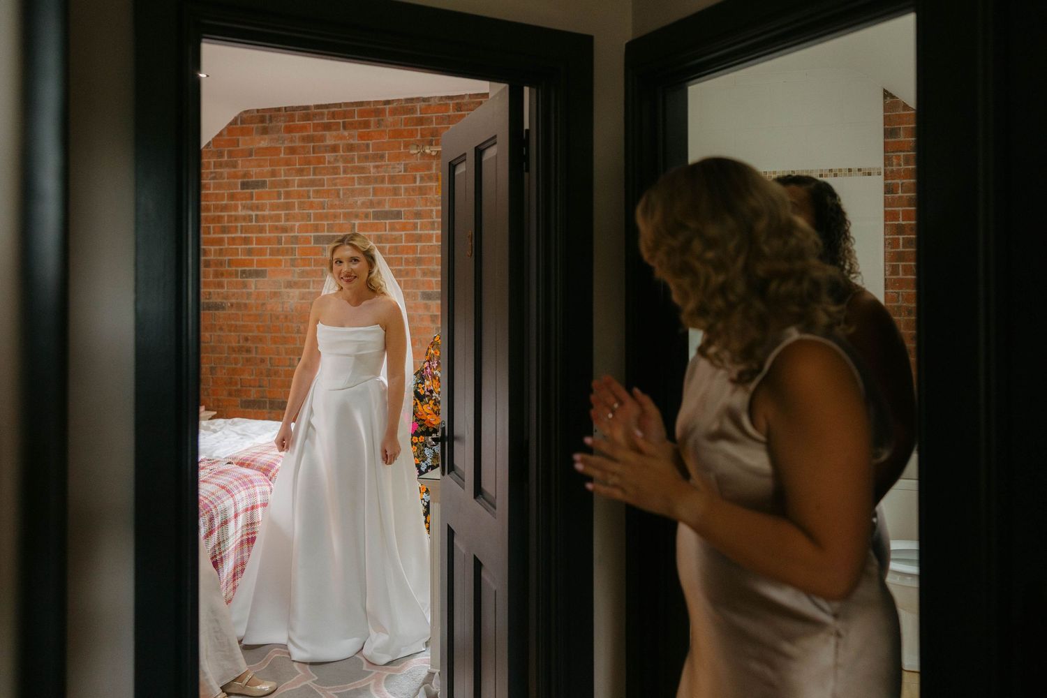 Dramatic doorway shots showing wedding dress details in natural light.