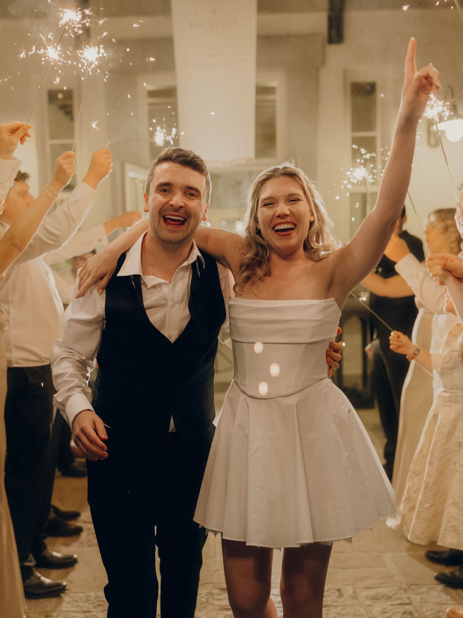 Wedding couple celebrates with sparklers during their reception party.