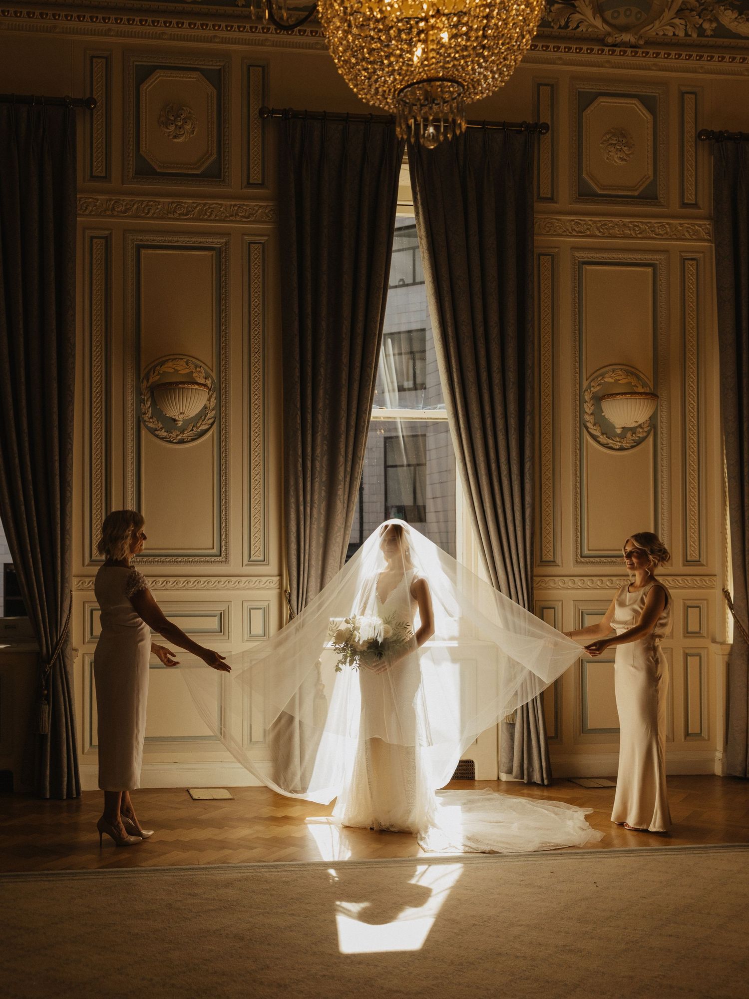 Five sequential frames capture an ethereal dance performance in an ornate ballroom with a crystal chandelier.