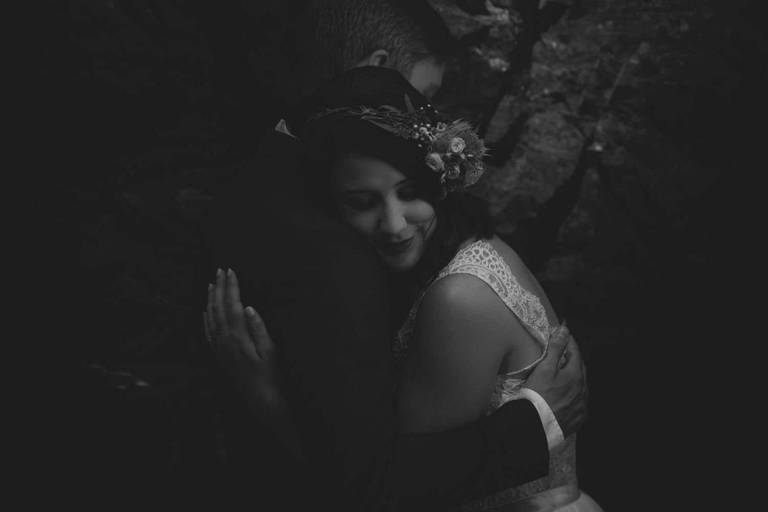 Intimate wedding moment captured in dramatic black and white photography.