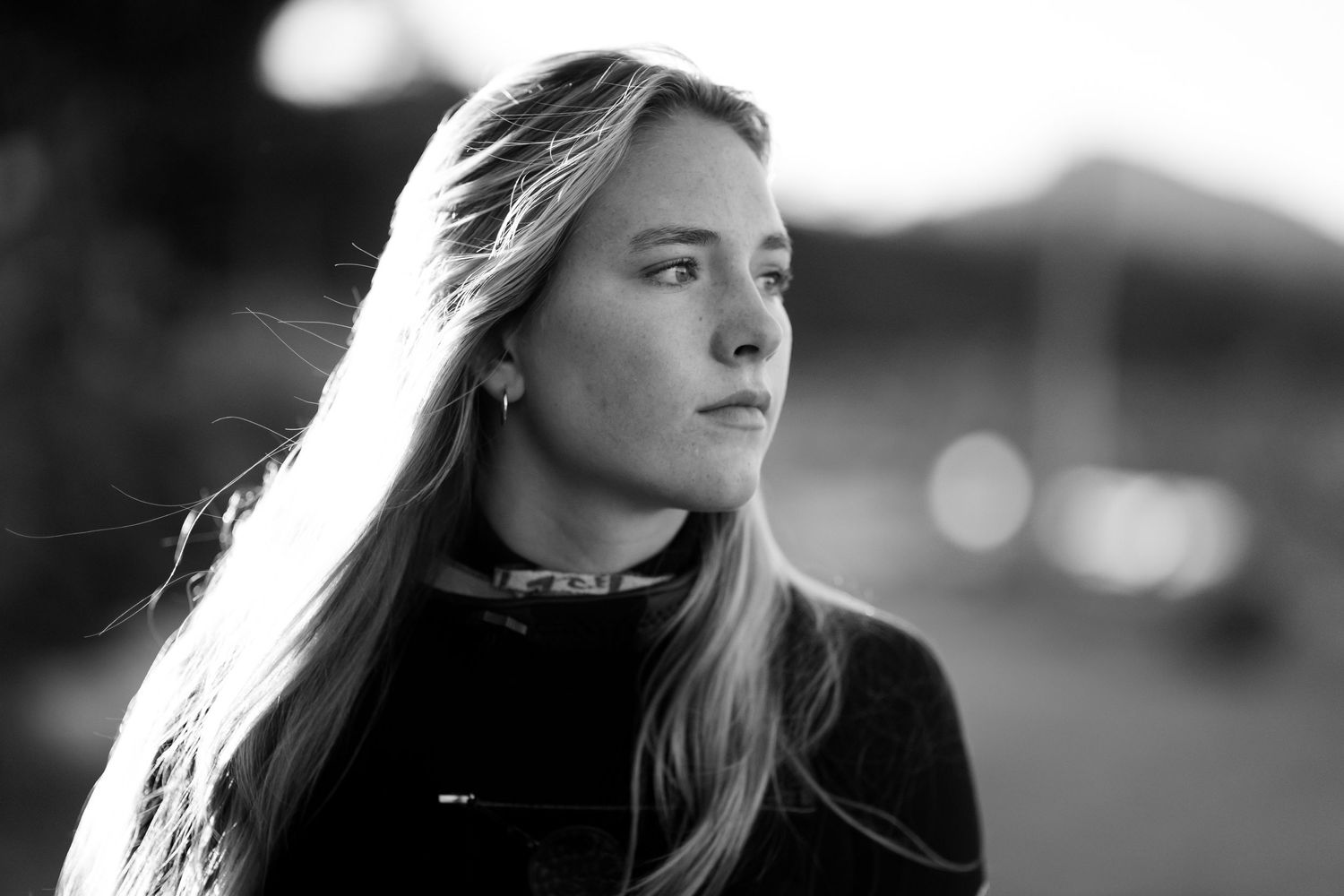 Black and white artistic portrait series showing close-up profile views with dramatic lighting and bokeh effects.