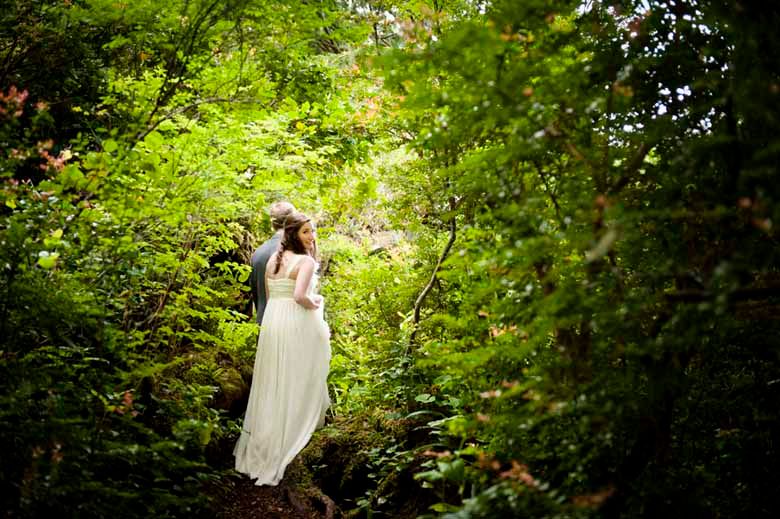 A dreamy woodland photoshoot with sunlight filtering through lush green foliage.