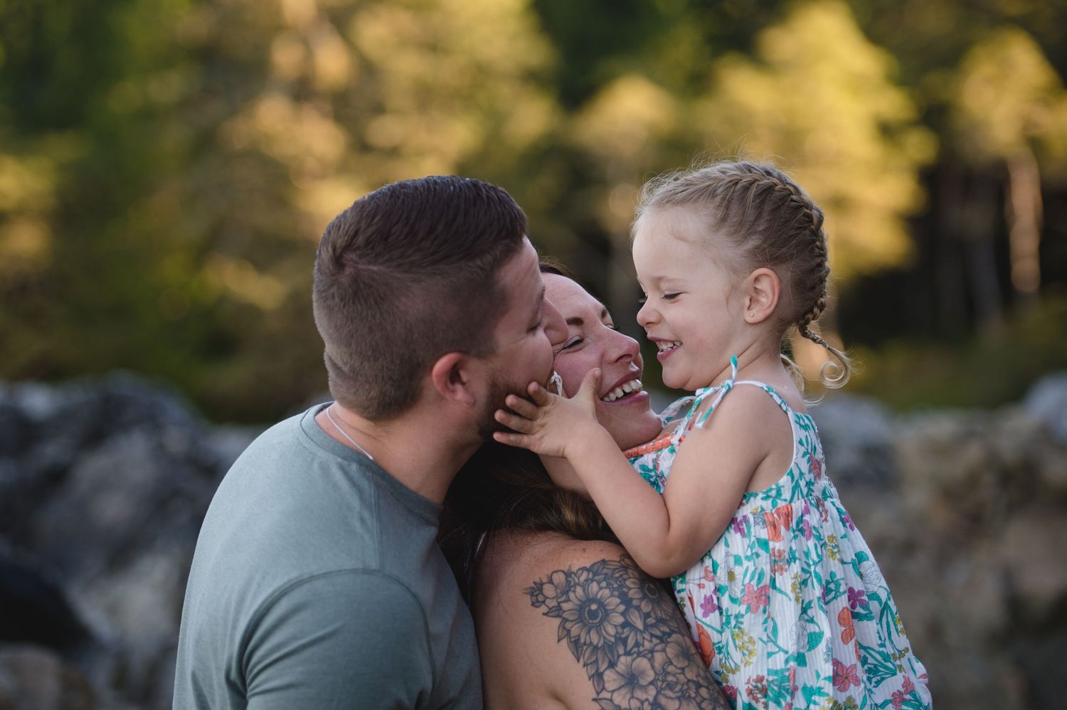 A touching family moment shared between loved ones against a natural outdoor setting.