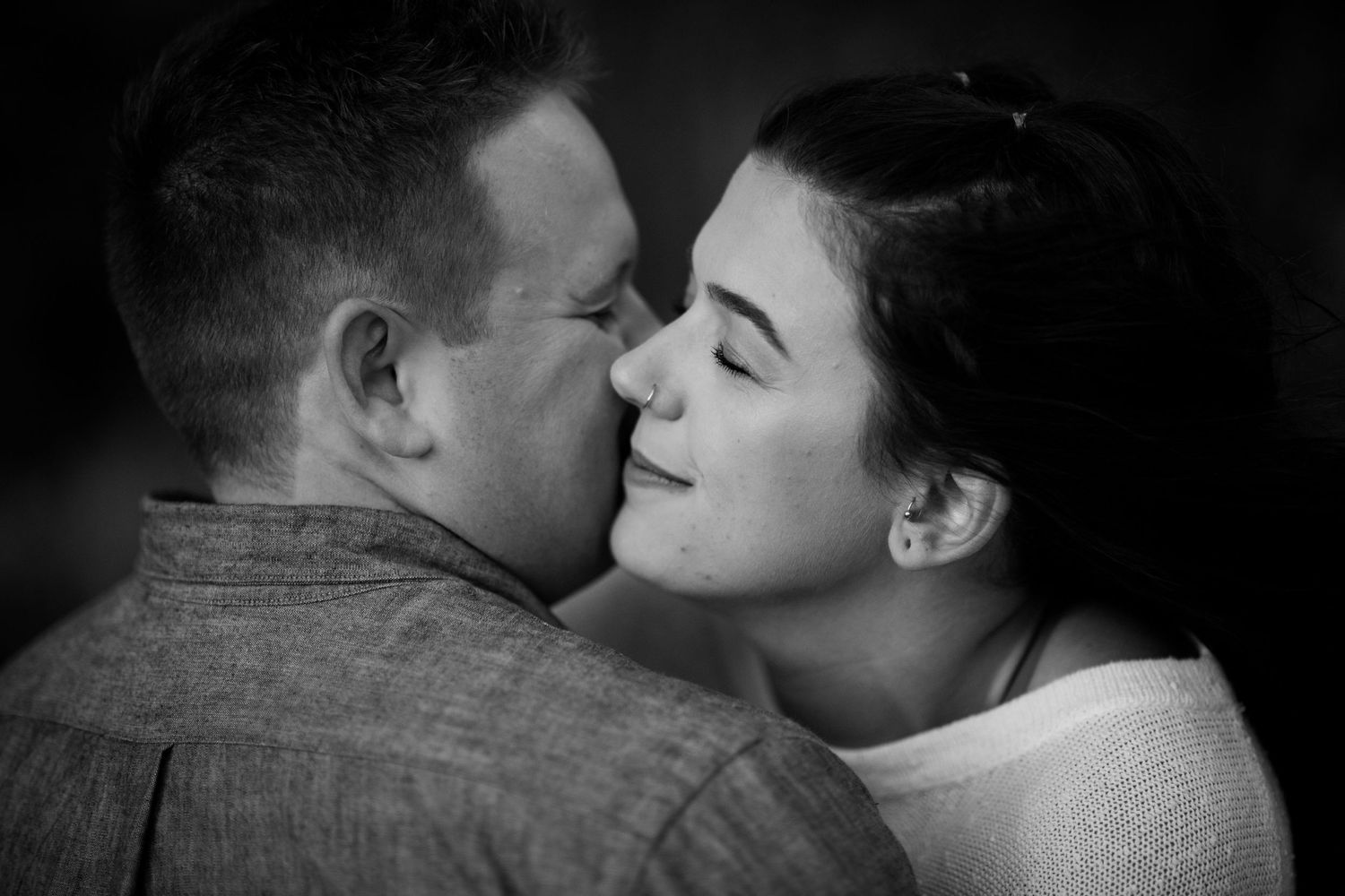 Intimate black and white portrait session on a moody coastal beach.