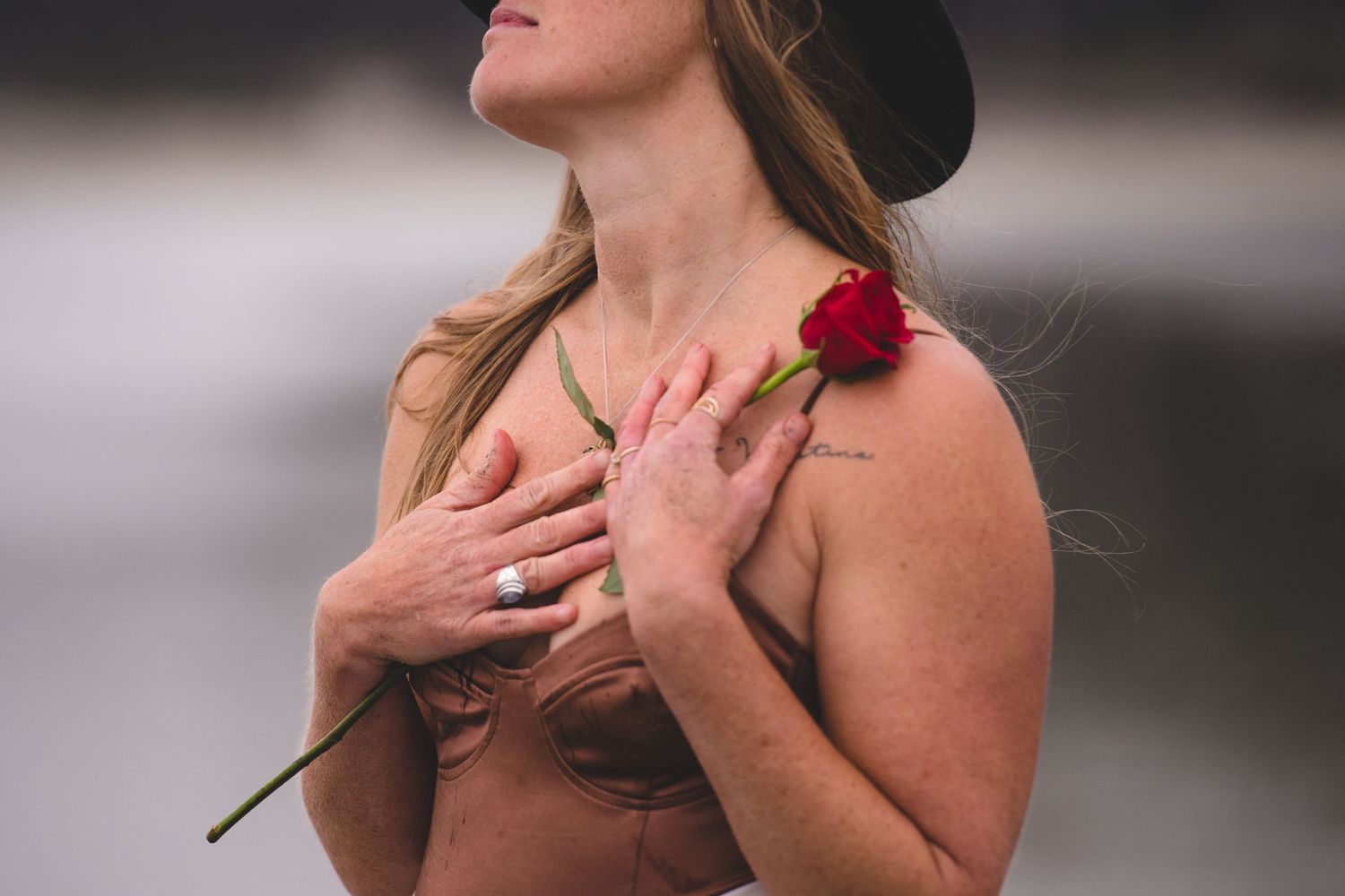 Side profile shots of a woman holding a red rose against a dark background.
