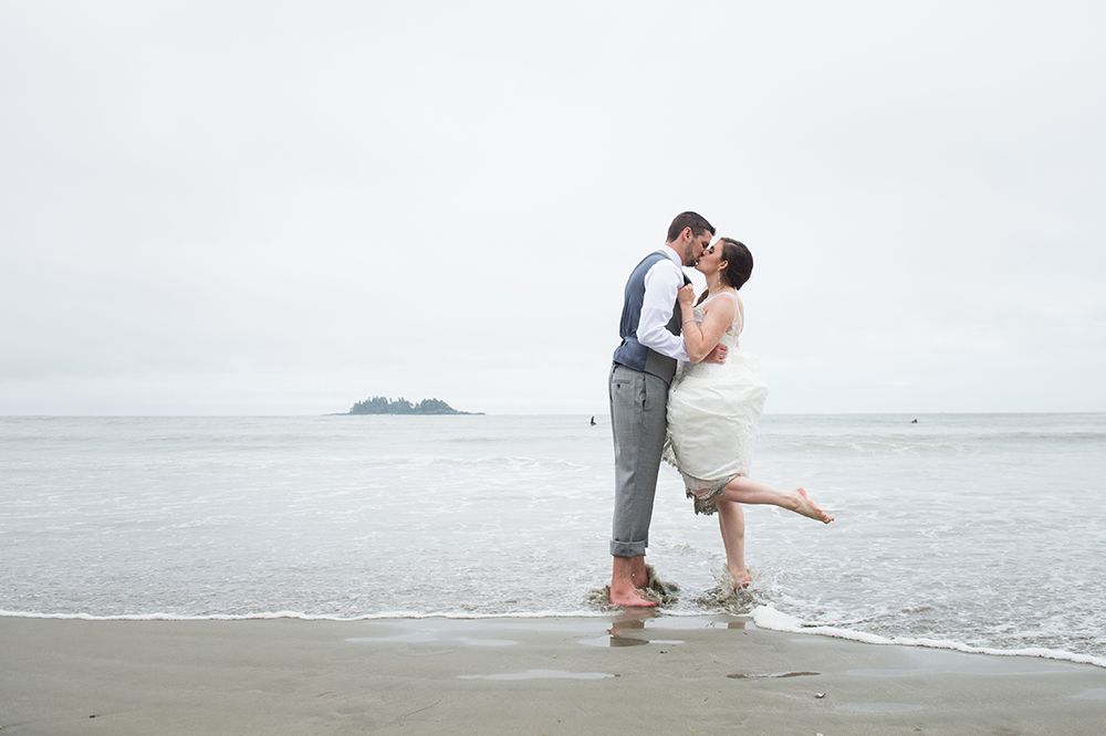 Romantic moments captured along the shoreline during a beach wedding celebration.