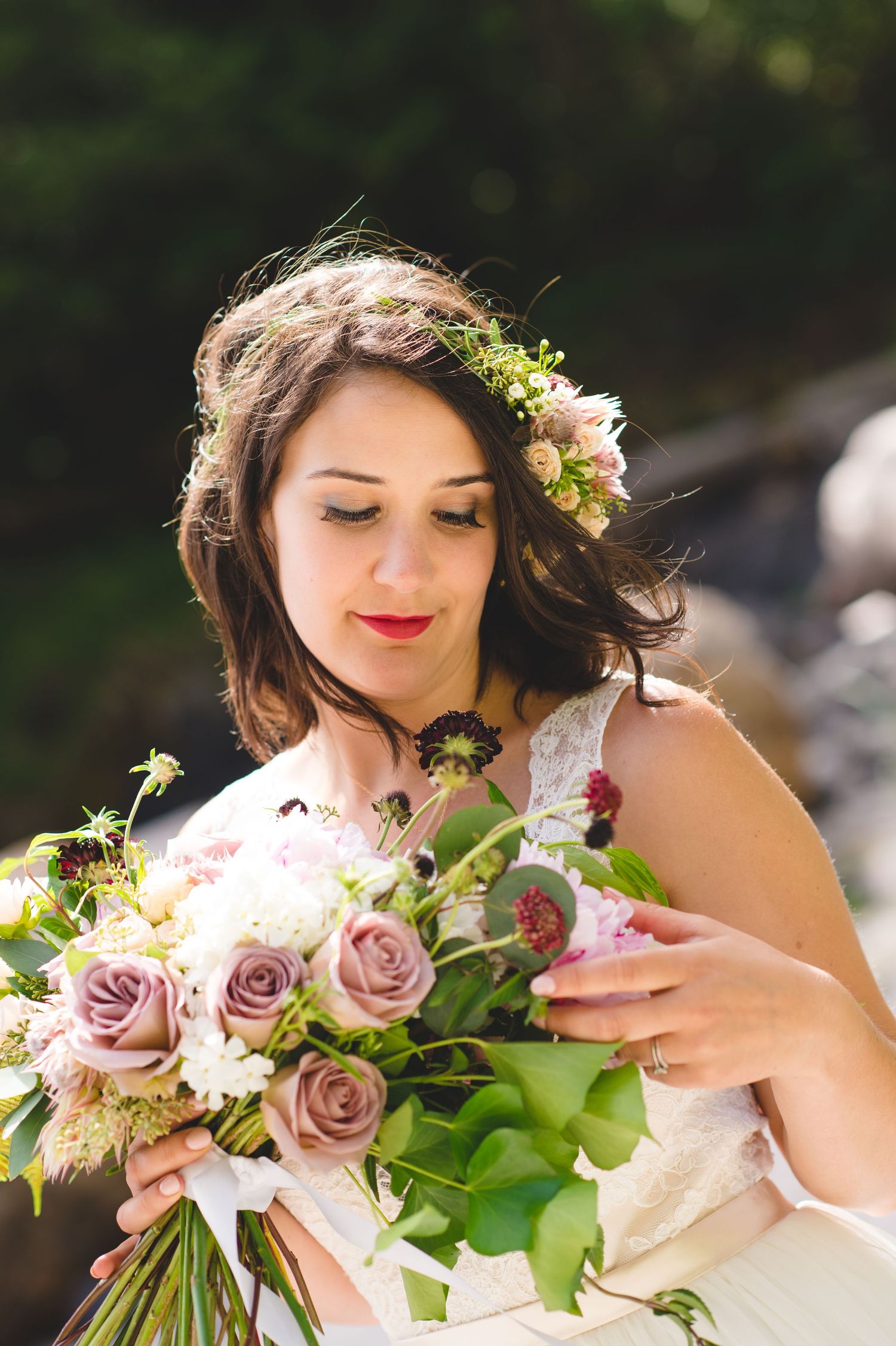 Bridal bouquet featuring mauve roses and mixed flowers with natural greenery.
