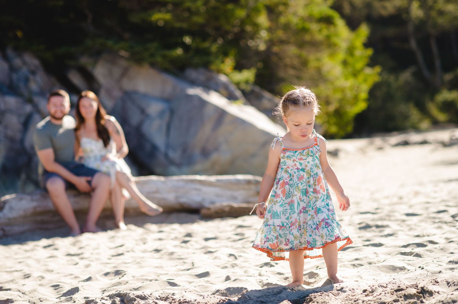 Candid moments of beach play captured against rocky coastal scenery.