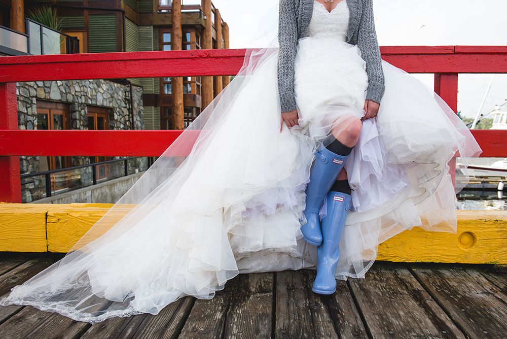 Wedding party poses along red and yellow painted walls in casual style.
