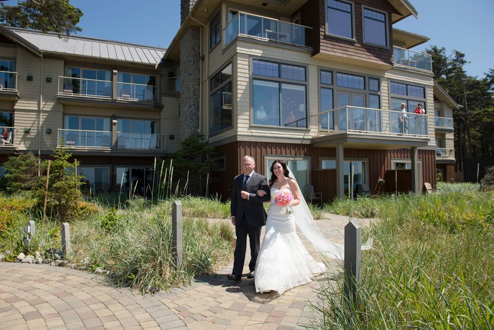 Modern waterfront home with glass windows serves as backdrop for special occasion.