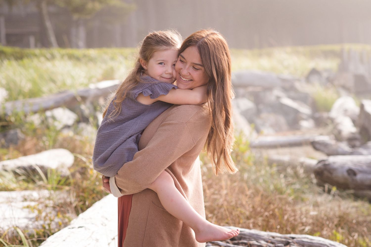 A heartwarming moment shared between two people in soft golden light by the beach.