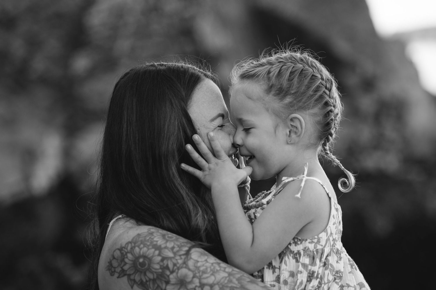 Black and white intimate portrait series showing tender moments at the beach.