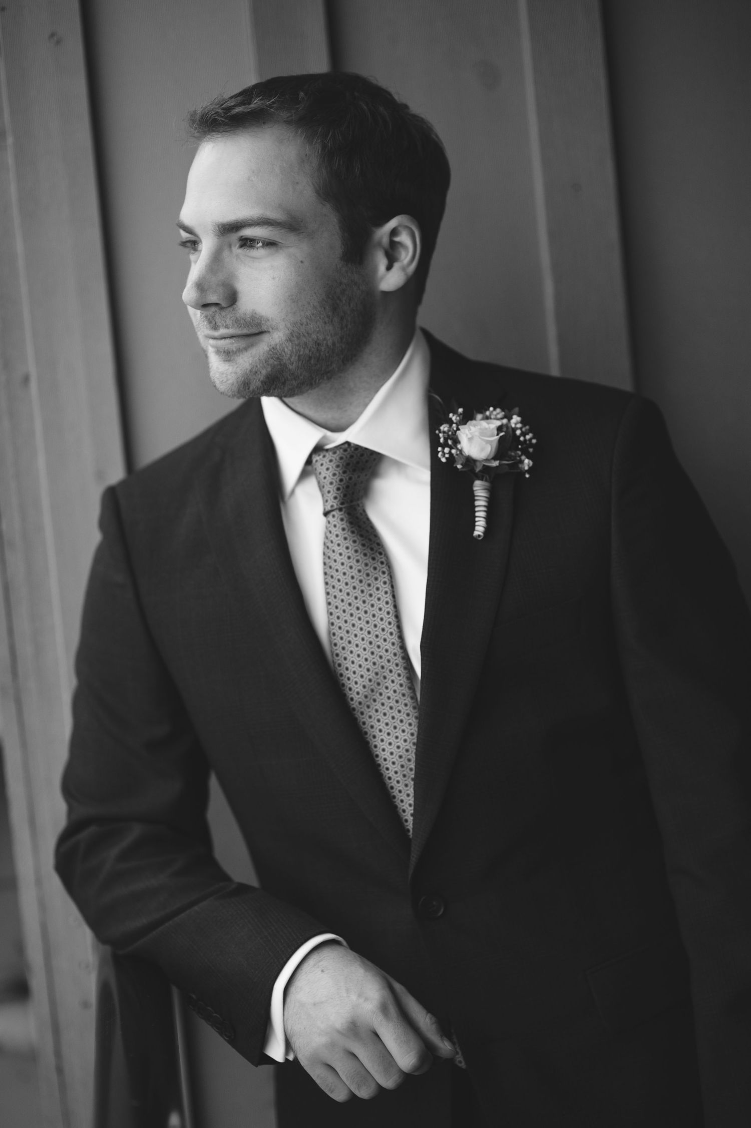 Black and white portraits of a person in a suit with boutonniere.