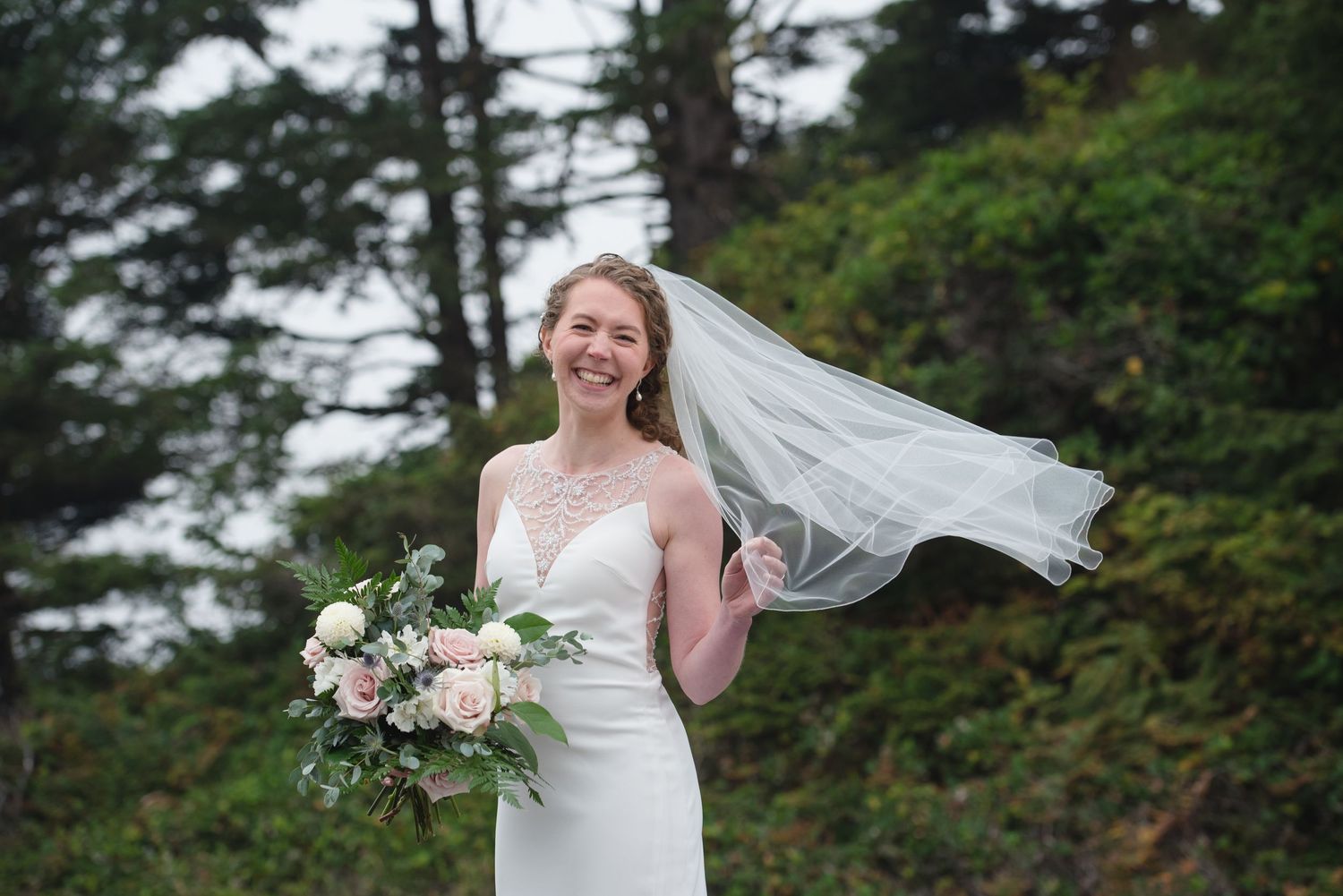 Wedding portraits in a lush forest setting with flowing veil and delicate floral bouquet creating ethereal moments.