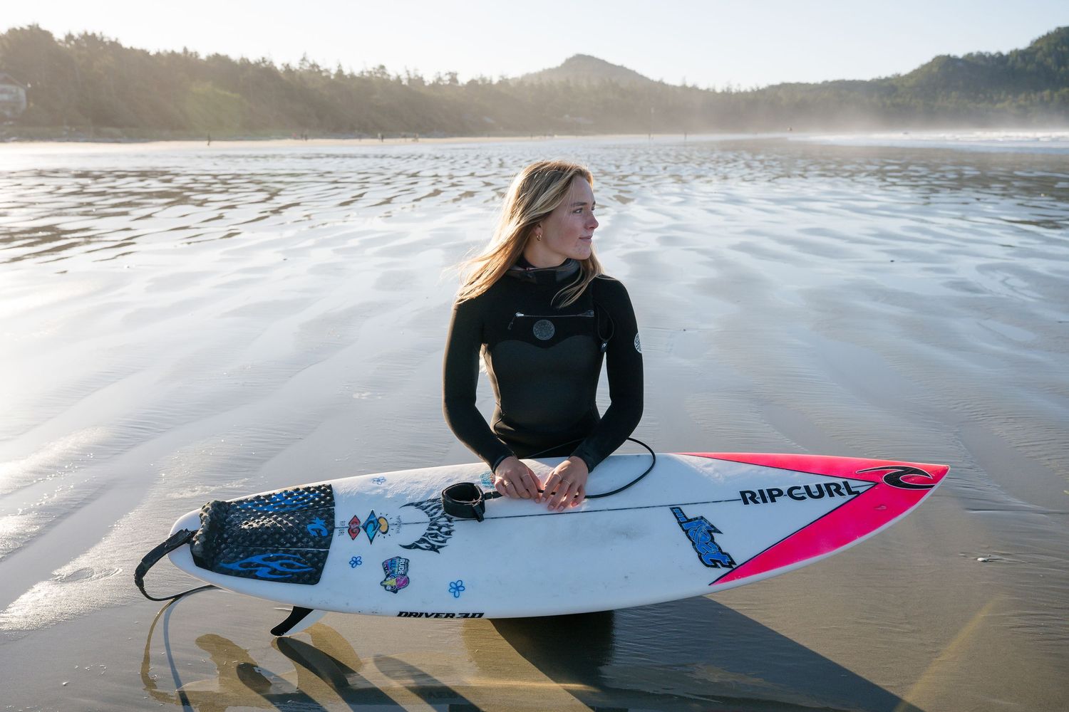 Row of surfing photos showing surfer with pink board on beach at different angles.
