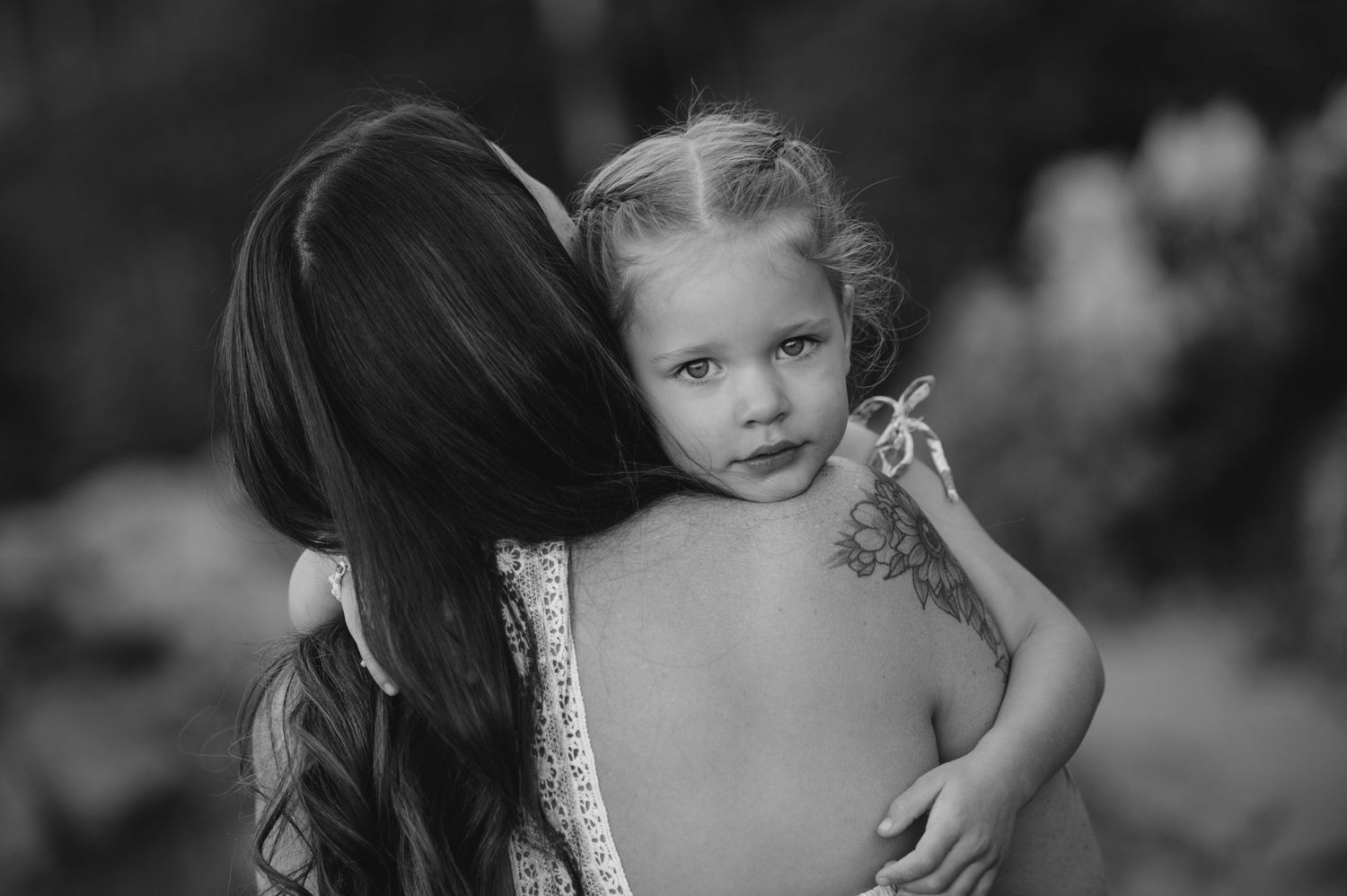 Black and white portrait series showing emotional connections during a beach session.