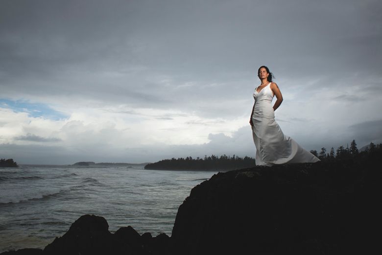 Dramatic stormy seascape with waves crashing against rocky coastline under moody grey skies.