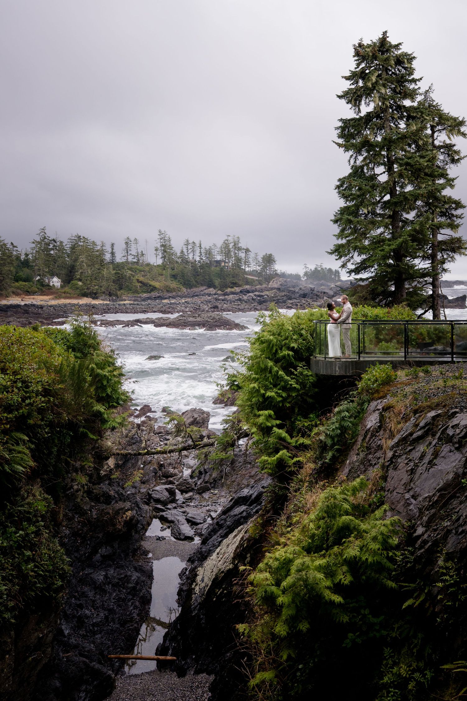 Dramatic coastal landscape with rocky cliffs and evergreen trees overlooking the Pacific Ocean in Ucluelet.