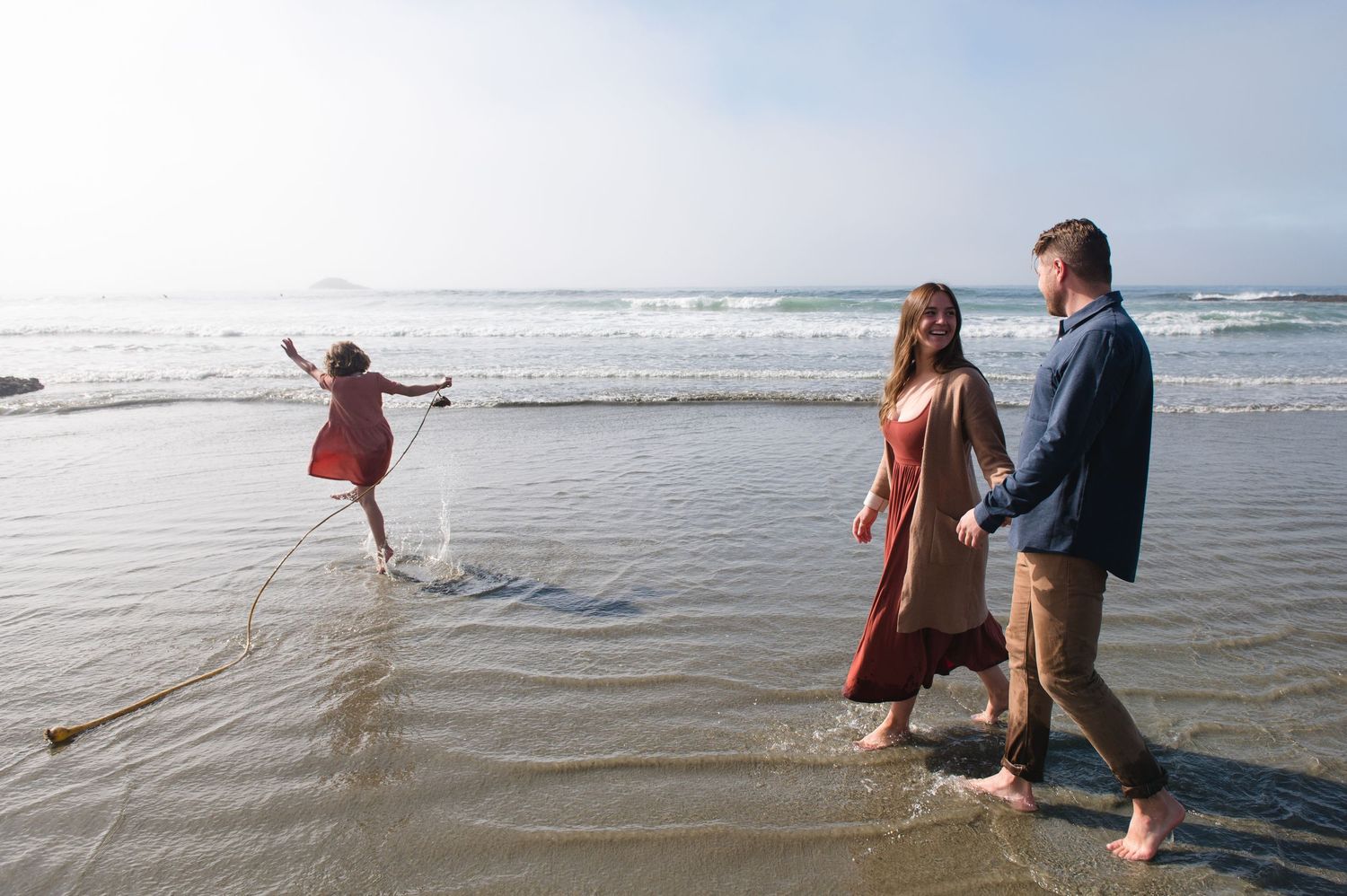People exploring tidal pools and playing at beach during low tide.
