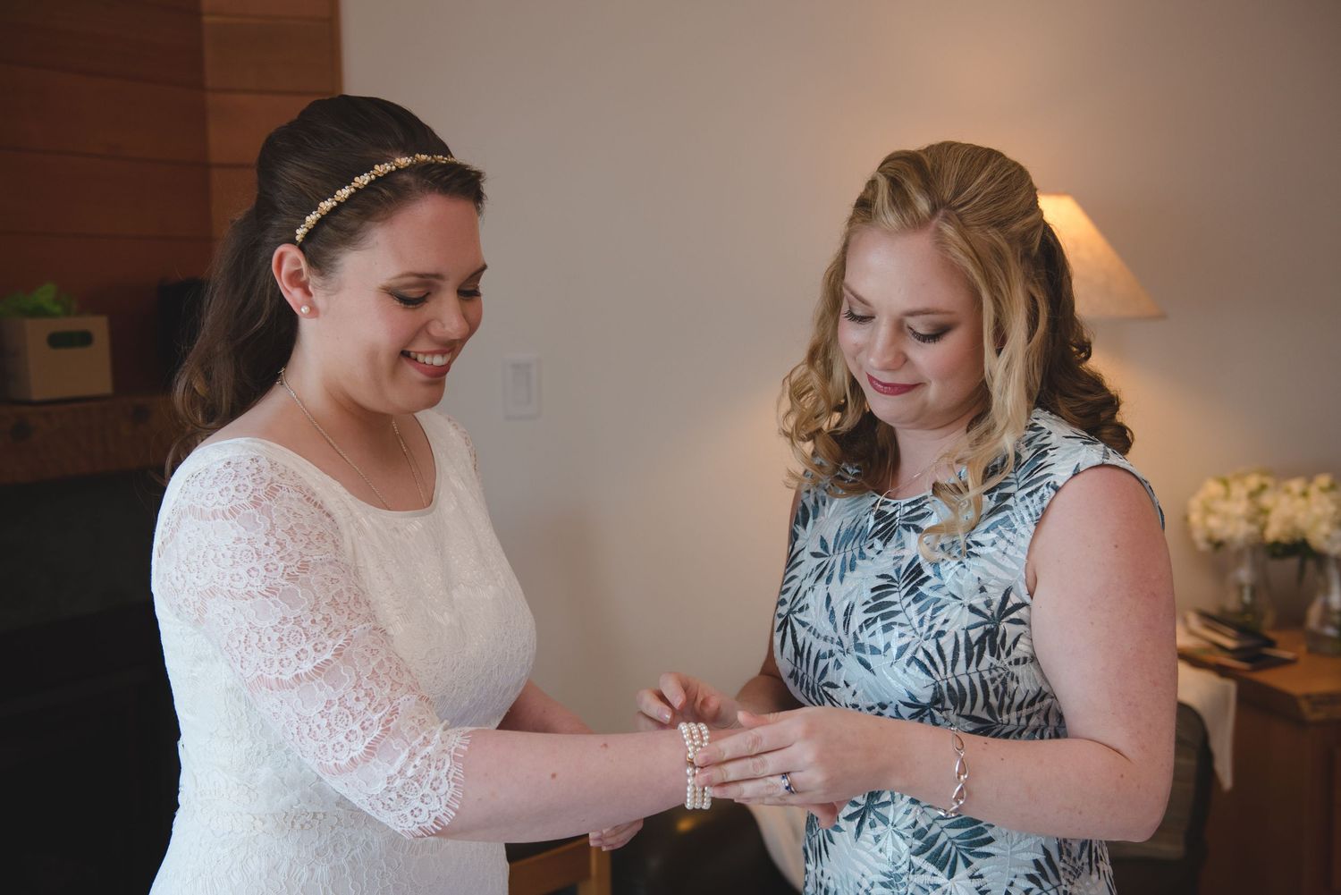 Wedding party members admire jewelry and accessories before the ceremony.