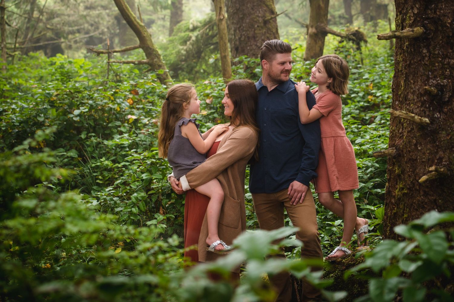 Intimate family moments captured in a serene woodland setting.