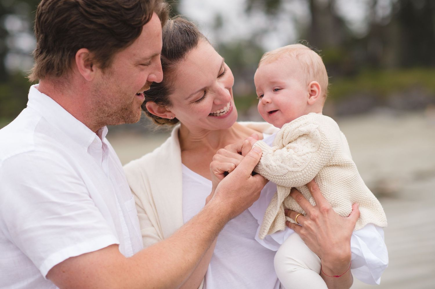 Tender family moments captured in soft light at the beach.