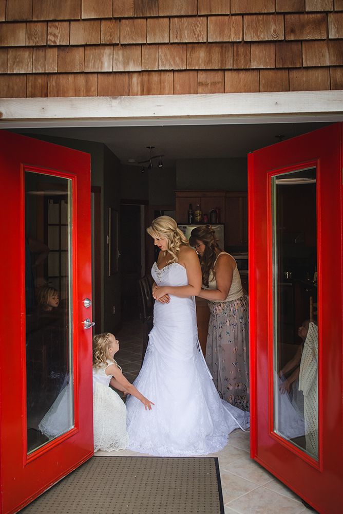 Interior hallway with red-framed mirrors and white wedding dress reflections.