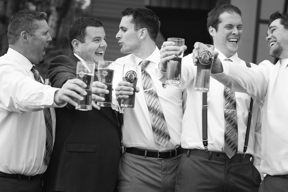 Group celebrating with drinks and laughter at an indoor gathering.