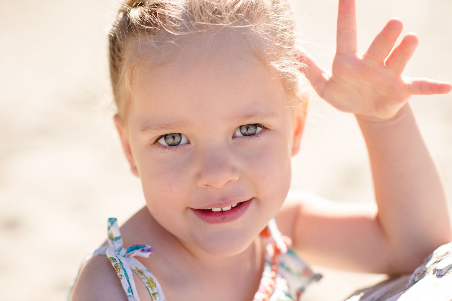 Close up portrait of smiling child with bright eyes in natural lighting.
